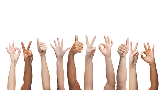 human hands showing thumbs up, ok and peace signs